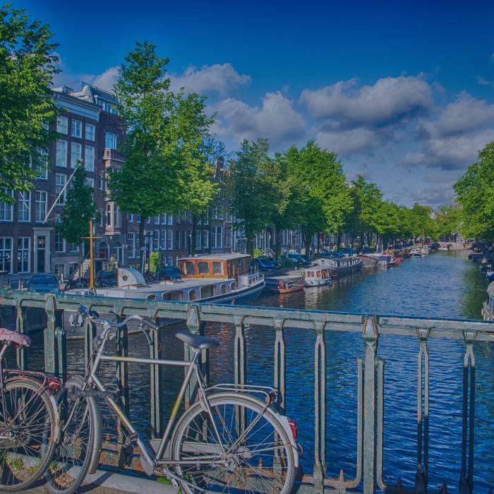 Amsterdam bridge with bikes view of buildings