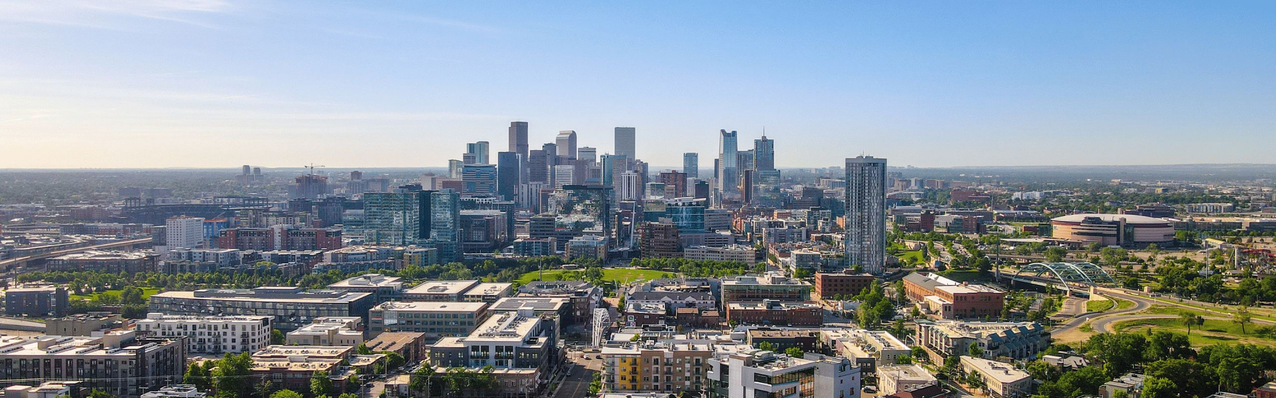 Panoramic photo of Denver city skyline with residential buildings in the foreground