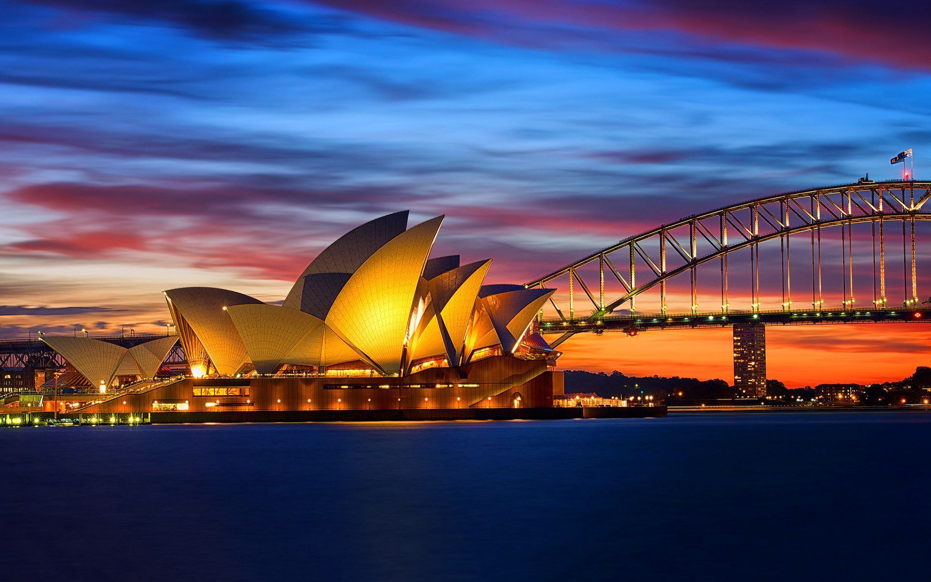 Sunset view of Sydney opera house across water