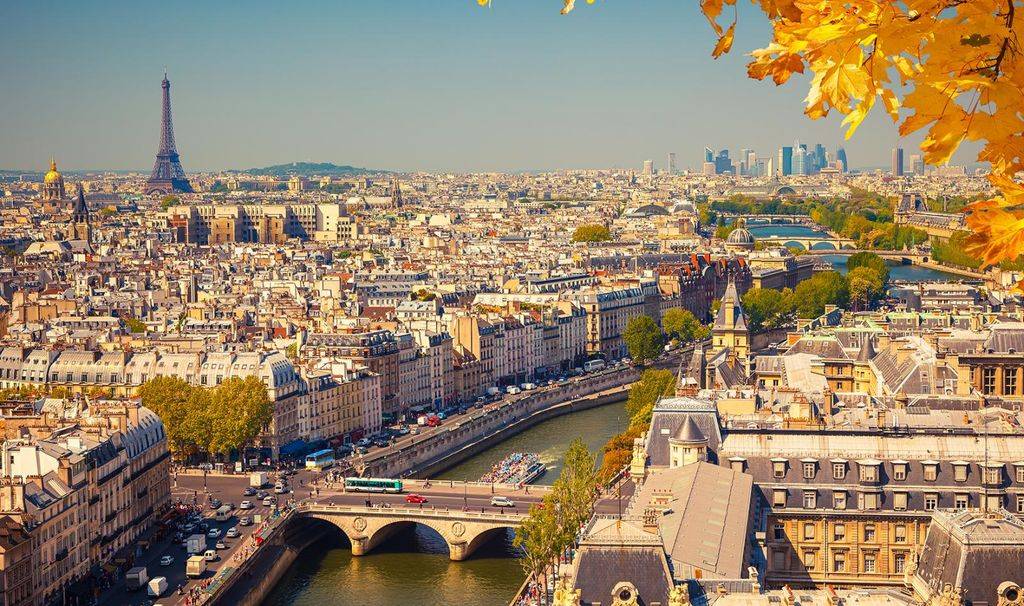 Photo of Paris overlooking Seine River with Eiffel tower in distant background, in Fall season