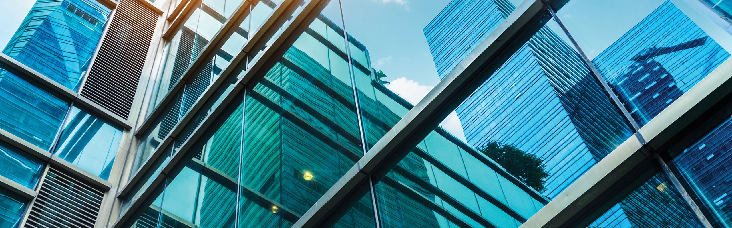 Close-up abstract shot of glass office buildings blue tint