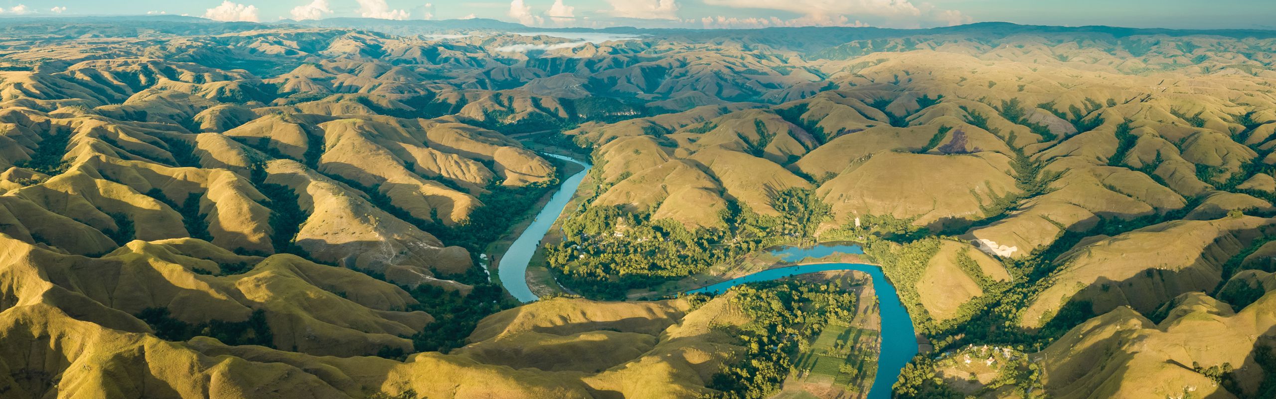 Mountains with a blue river winding between