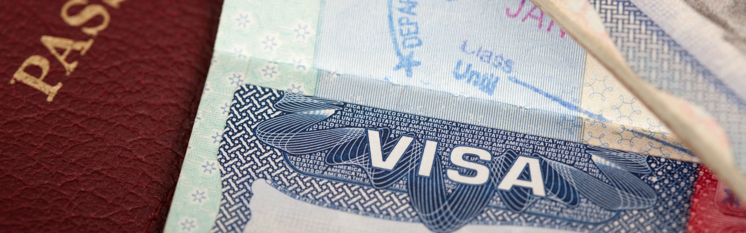 Image of a visa next to a passport
