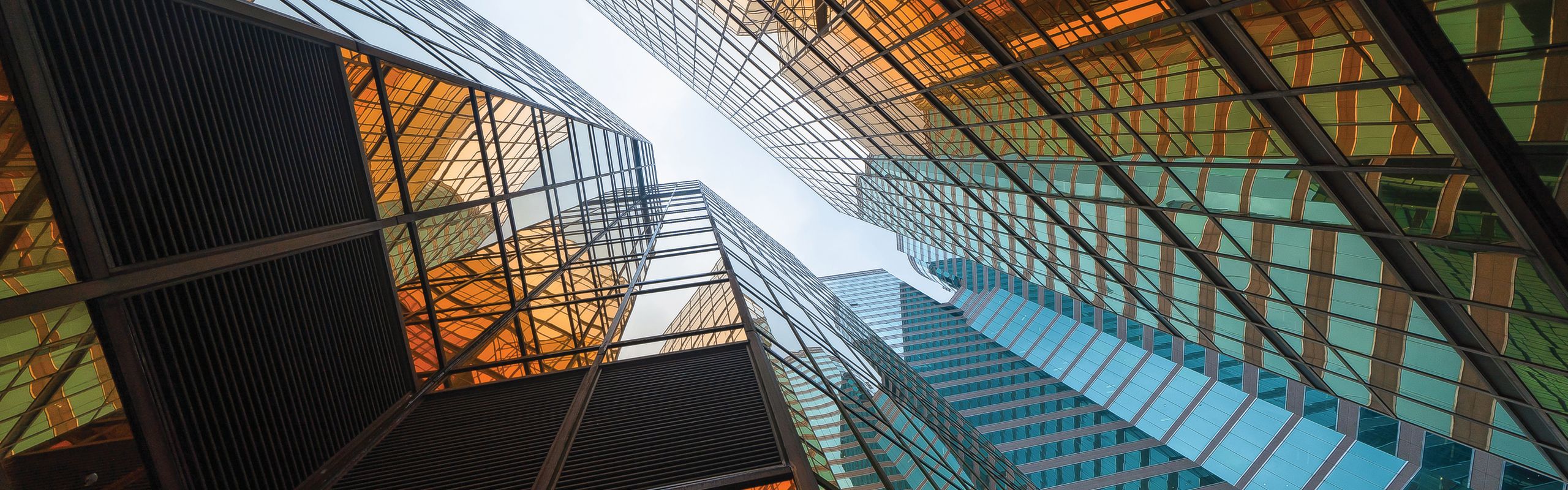 Worm's eye view of glass office buildings