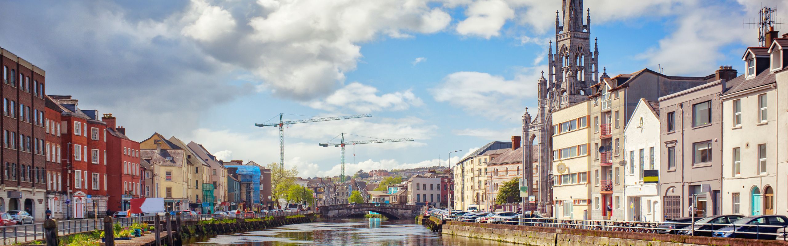 Skyline of Cork Ireland over the river with cranes in background