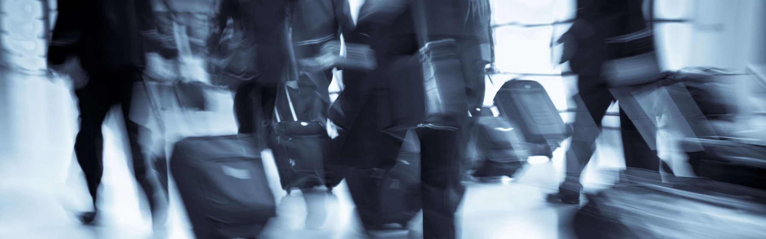 Crowd of business professionals traveling, blurred
