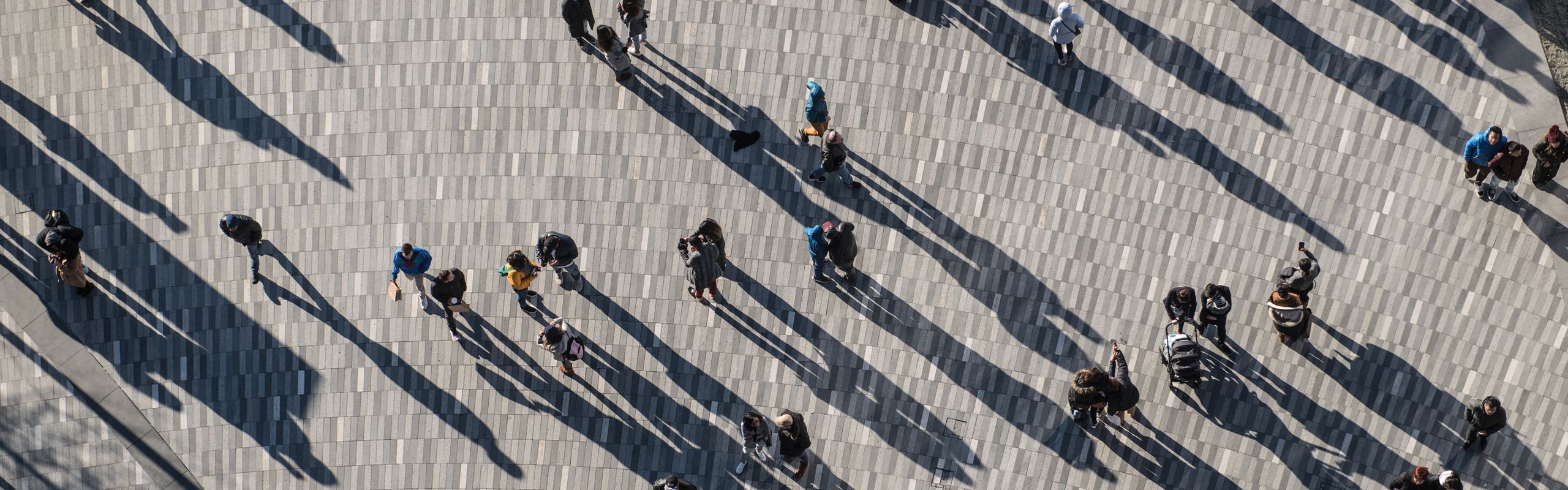 people walking with shadows behind them