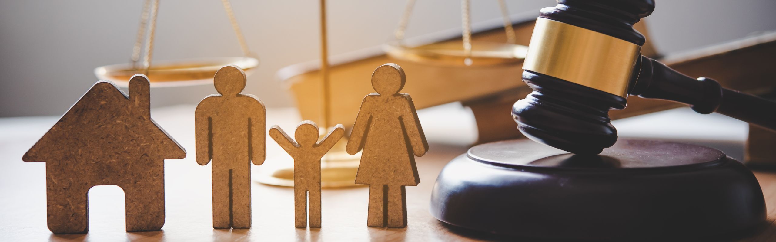 Image of a gavel next to figures of people and a house