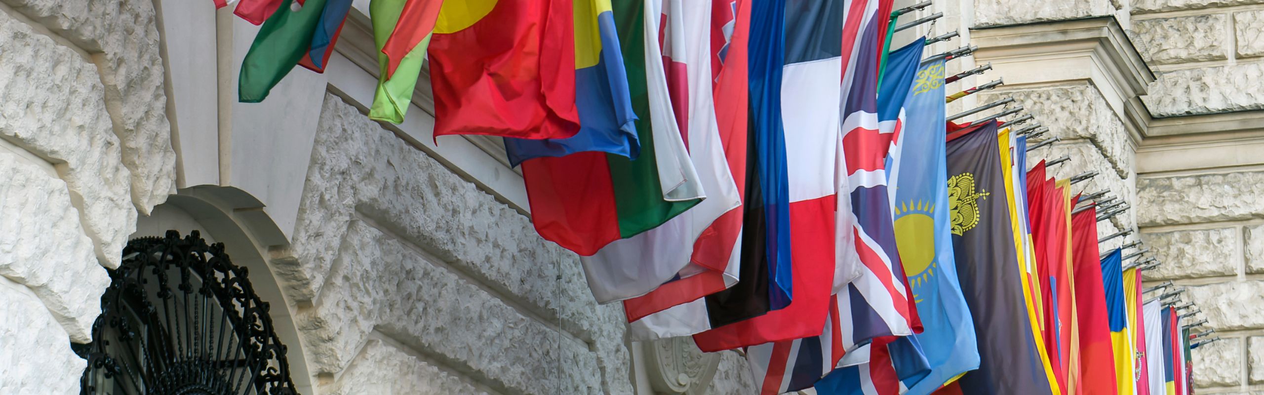 Flags hanging along building wall