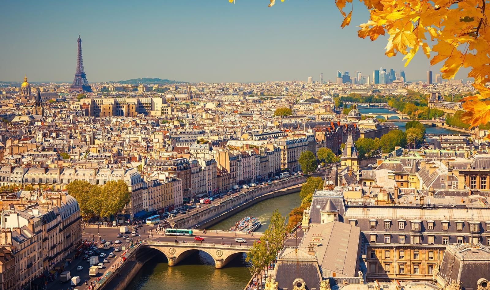 Photo of Paris overlooking Seine River with Eiffel tower in distant background, in Fall season