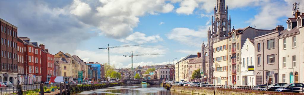 Skyline of Cork Ireland over the river with cranes in background