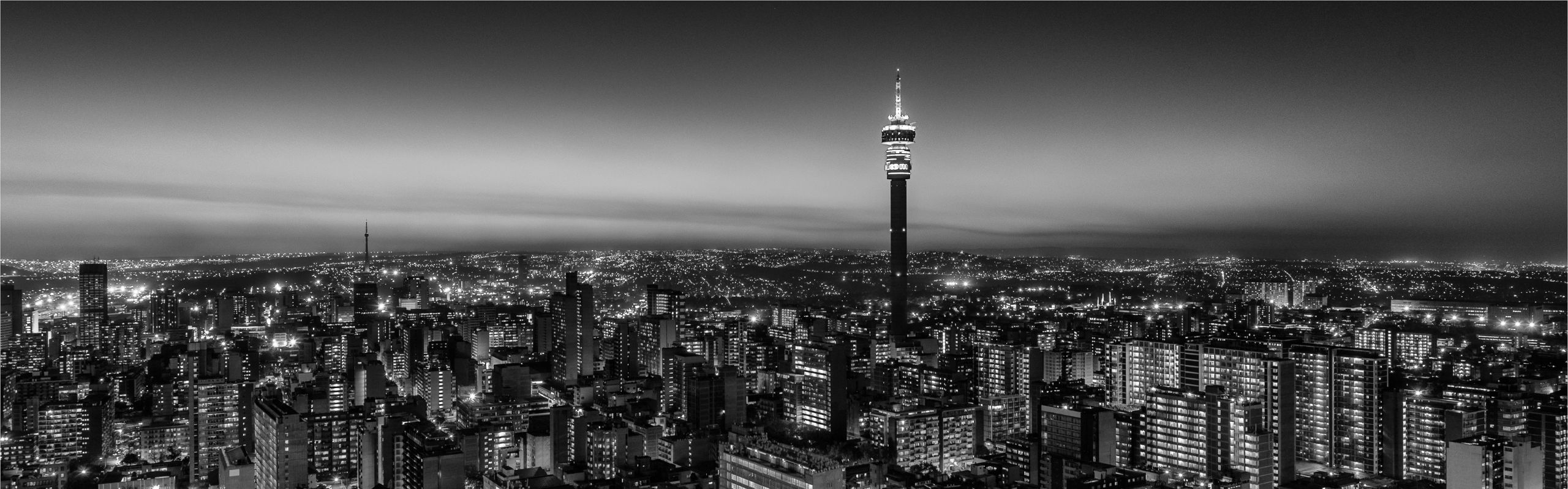 Grayscale image of Johannesburg skyline at night